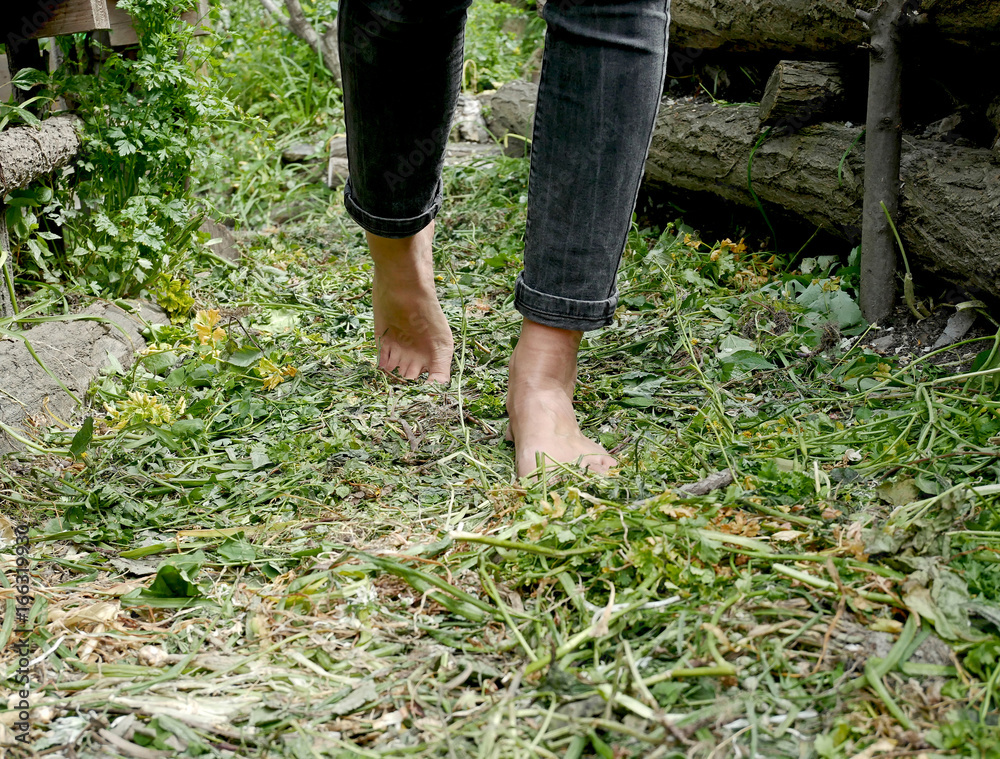 Girl walking barefoot in the garden Girl walking barefoot in the garden