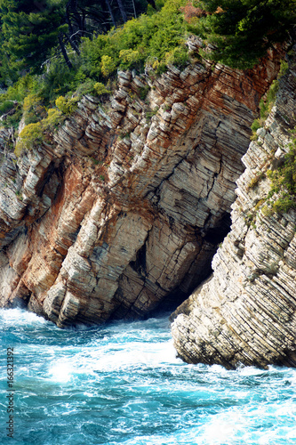 Layered rocks and the Adriatic Sea in the Montenegrin city of Petrovac