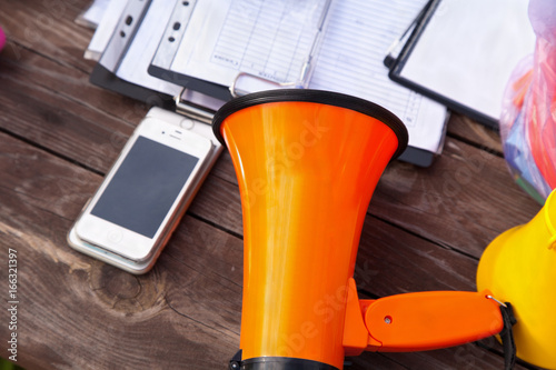 Orange megaphone on a wooden table