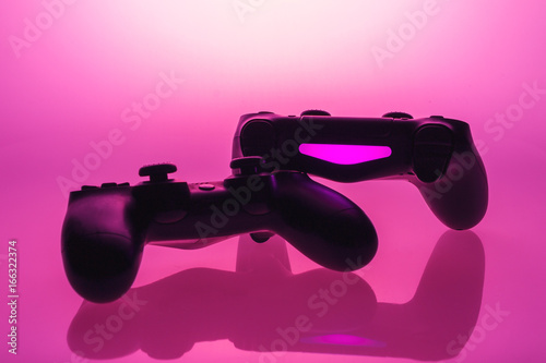 gaming controller on pink background © Robert Herhold