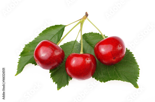 Fotografija Berries of red cherry with leaves on white background