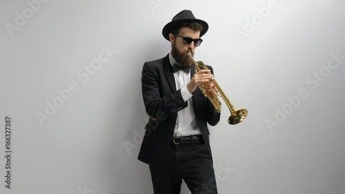 Trumpet player against a wall