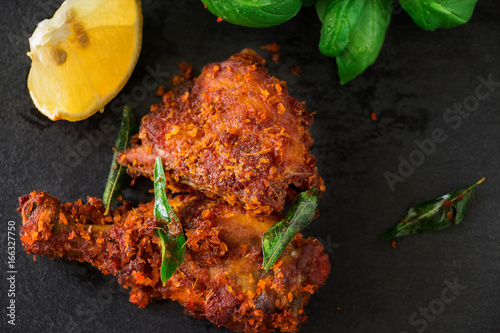 Fototapet Authentic Indian Chicken fry with spices, curry leaf and coconut - payyoli chicken fry