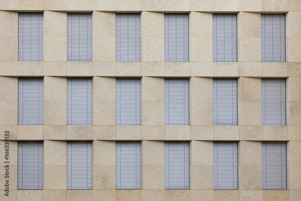 facade of office building with closed shutter blinds
