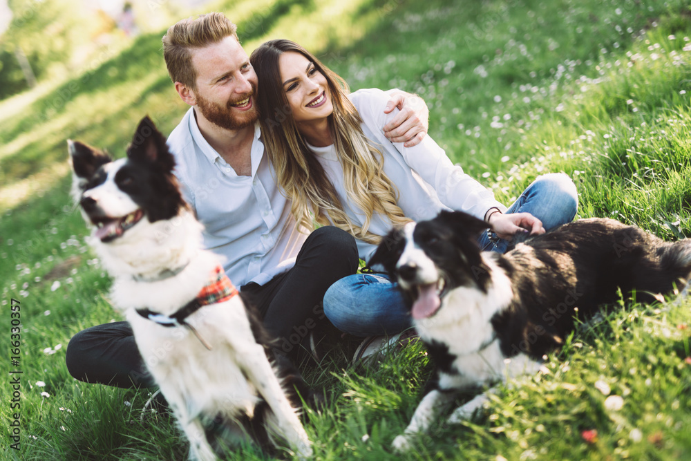 Beautiful couple walking dogs and bonding in nature Beautiful couple walking dogs and bonding in nature
