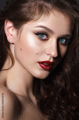Close up portrait of beautiful young model with professional makeup  perfect skin. Trendy eyelines and red lips. Hollywood star style