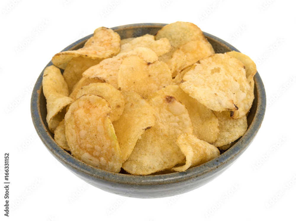 Stoneware bowl filled with salt and vinegar flavored potato chips isolated on a white background. Stoneware bowl filled with salt and vinegar flavored potato chips isolated on a white background.