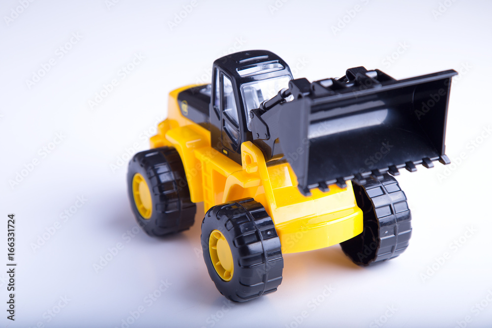 Children's toy yellow tractor  on white background