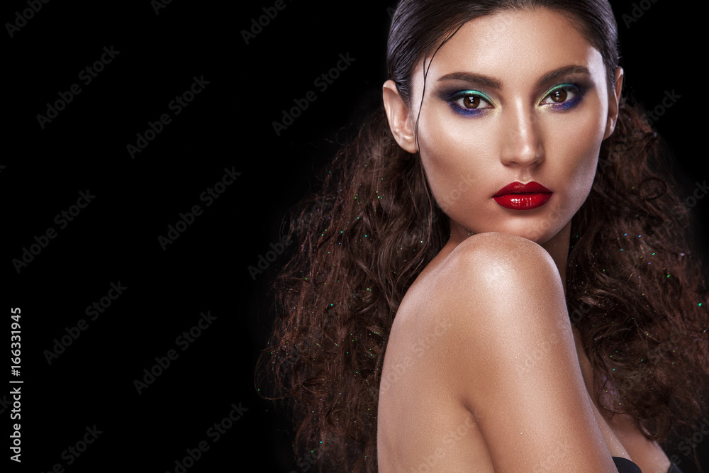 Stylish night flash fashion portrait of trendy casual young woman on black background with copy space.