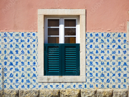 Facade of a Portuguese house decorated with vintage Portuguese tiles (azulejos)