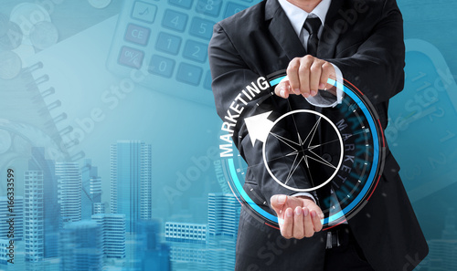 business man drive compass for marketing direction