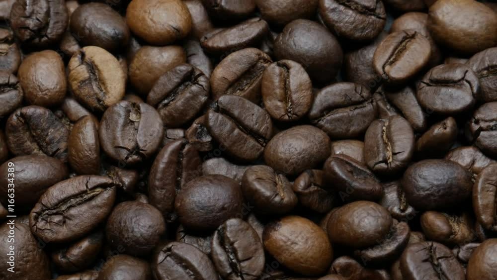 

Roasted coffee beans on dark background. Zoom out.