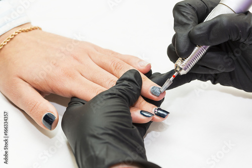 The process of manicure in the beauty salon is shot close-up 