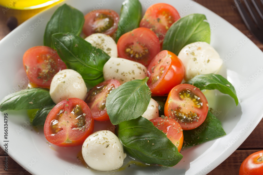 caprese salad in plate at wood caprese salad in plate at wood