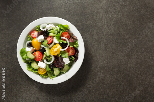 fresh greek salad in plate on stone