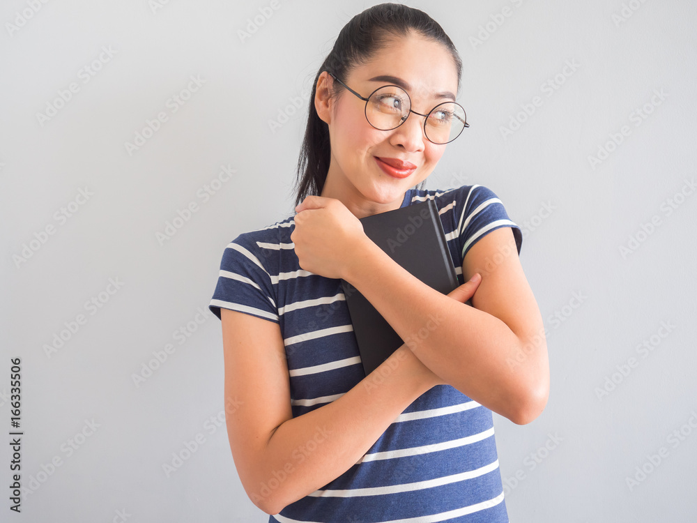 Happy nerdy woman holding a good book. Happy nerdy woman holding a good book.