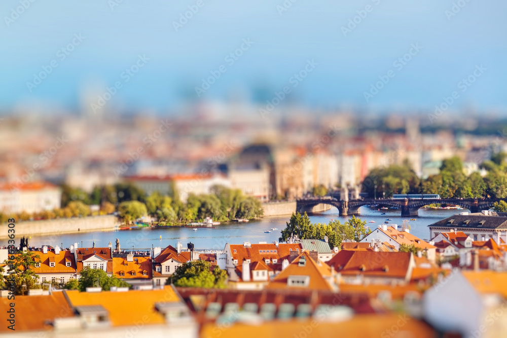 Fototapeta premium Aerial view of Prague, Czech Republic on a sunny evening. Miniature tilt shift lens effect