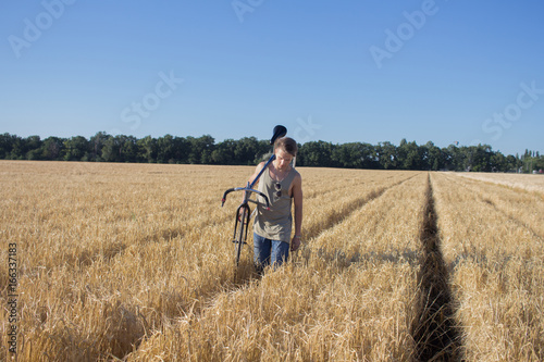 Young man ride fixed gear bike on the country road, fields and blue sky background   © serejkakovalev