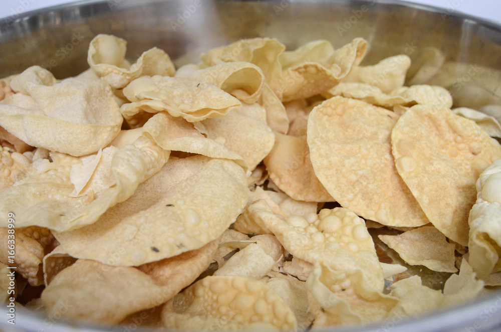 famous indian snack called papadam, can be taking together with rice famous indian snack called papadam, can be taking together with rice