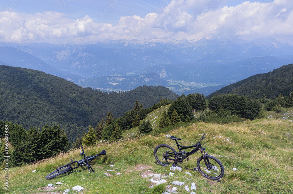Mountain bikes at Mozic, above Soriska planina with Julian alps in the background.