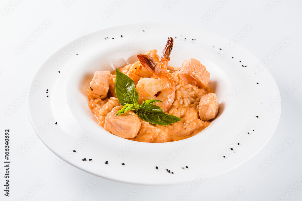 Risotto with shrimp and salmon in a mild creamy sauce (close)