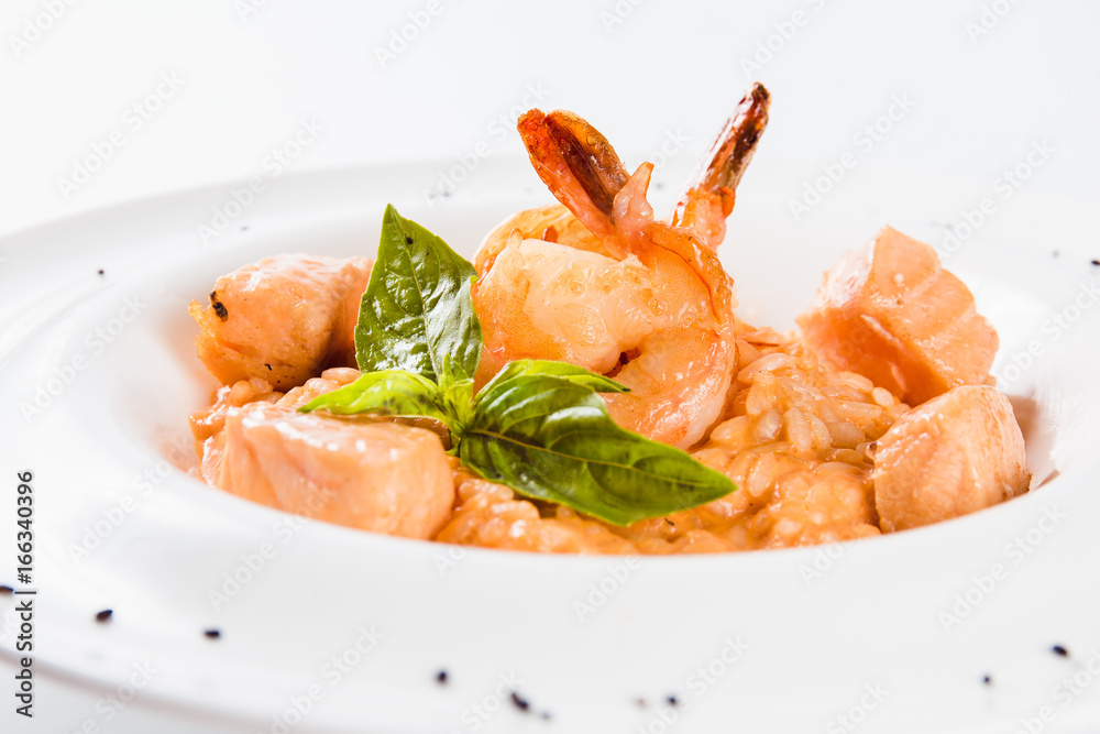 Risotto with shrimp and salmon in a mild creamy sauce (close) Risotto with shrimp and salmon in a mild creamy sauce (close)