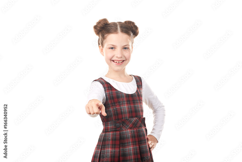 Portrait of cute girl in school uniform pointing at you against white background Portrait of cute girl in school uniform pointing at you against white background