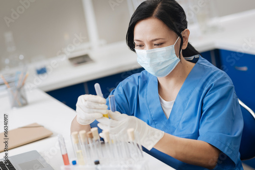 Professional lab working wearing a surgical mask