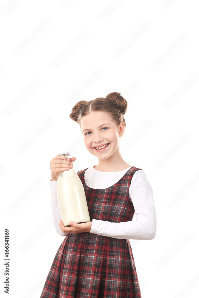 Portrait of cute girl in school uniform posing with milk bottle against white background Portrait of cute girl in school uniform posing with milk bottle against white background