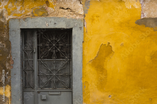 Door on yellow wall