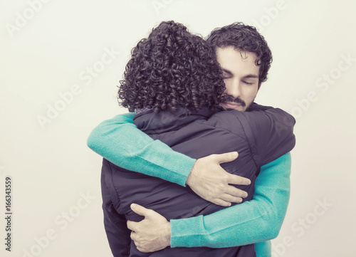Young man with beard is hugging girlfriend. © Vergani Fotografia