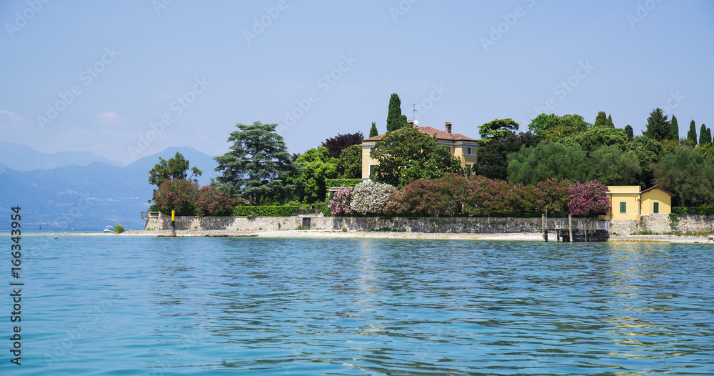 Sunny view of the city of Sirmione and Lake Garda in the foreground. Sunny view of the city of Sirmione and Lake Garda in the foreground.