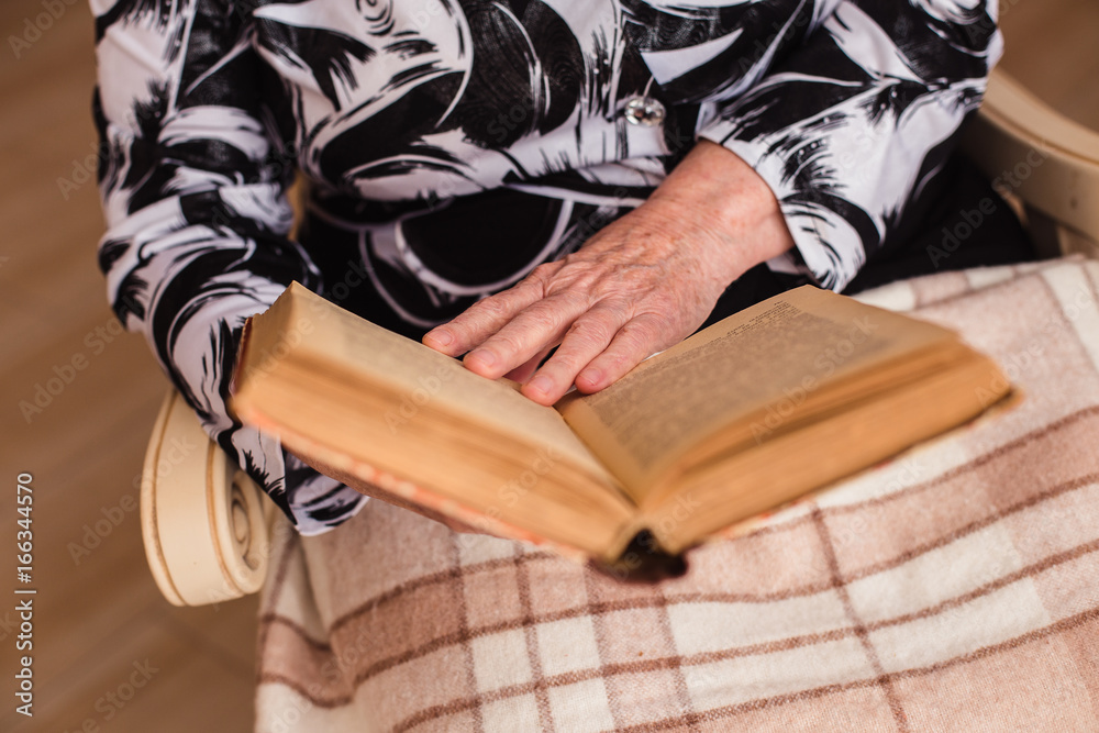 The old gray-haired woman reading a book