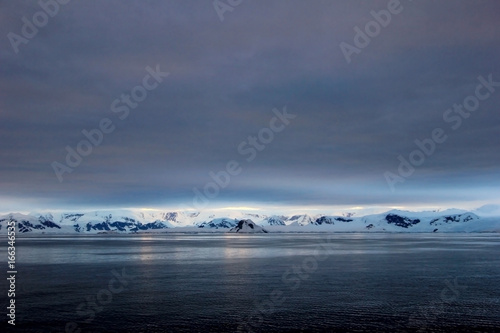 Antarctica landscape, icebergs, mountains and ocean at sunrise, Antarctica © reisegraf
