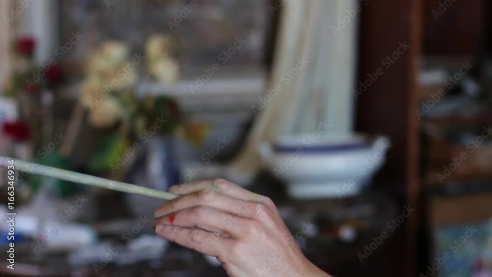 The hand with the artist's brush closeup The hand with the artist's brush closeup