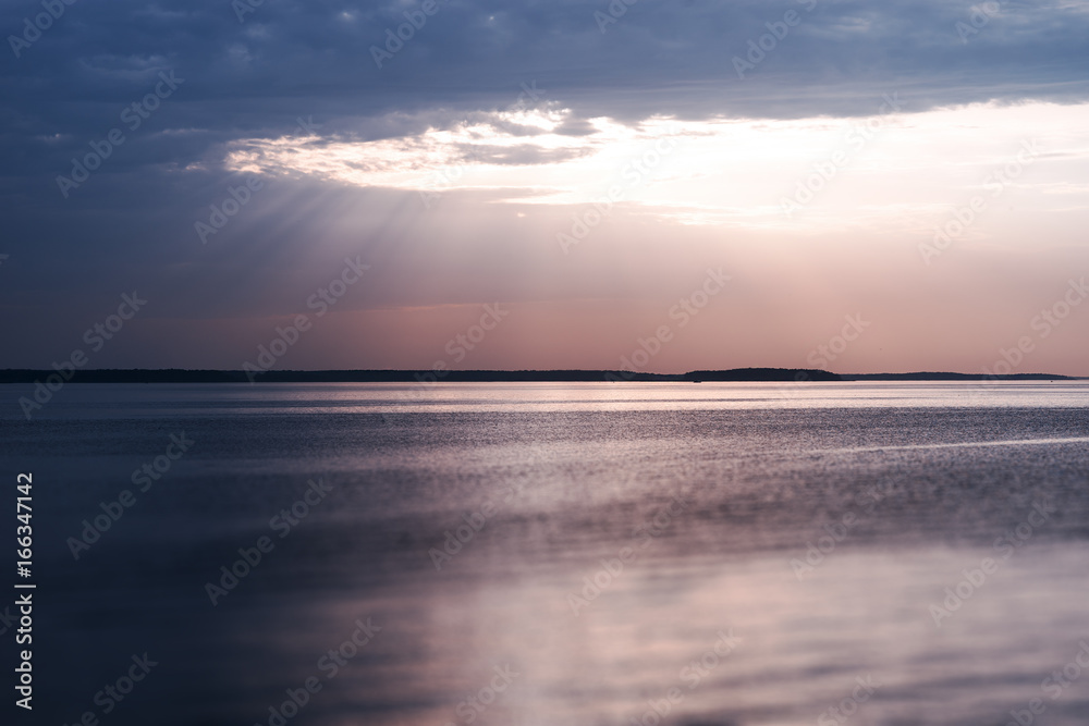 Obraz premium Sunset rays over the ocean landscape background