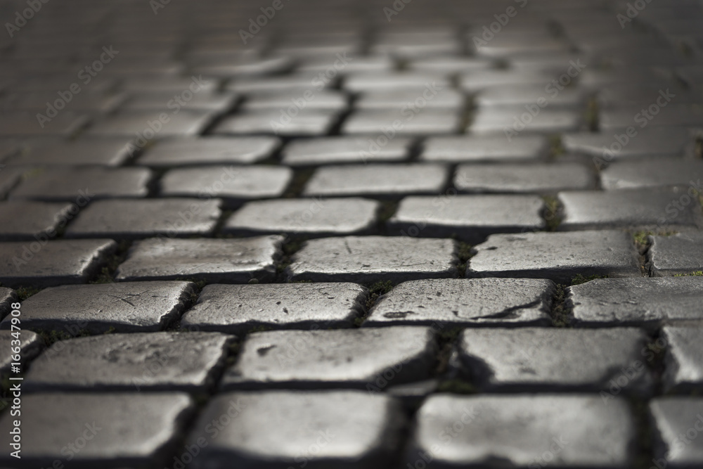 Very old roman stone pavement in the downtown of Rome, Italy. Ju Very old roman stone pavement in the downtown of Rome, Italy. Ju