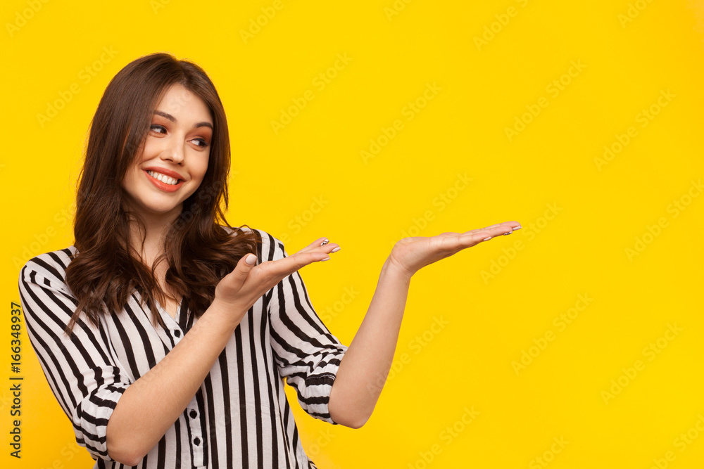 Model gesturing on yellow Model gesturing on yellow