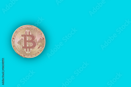 Golden bitcoin on blue background with copy space,Technology and finance concept © 220 Selfmade studio