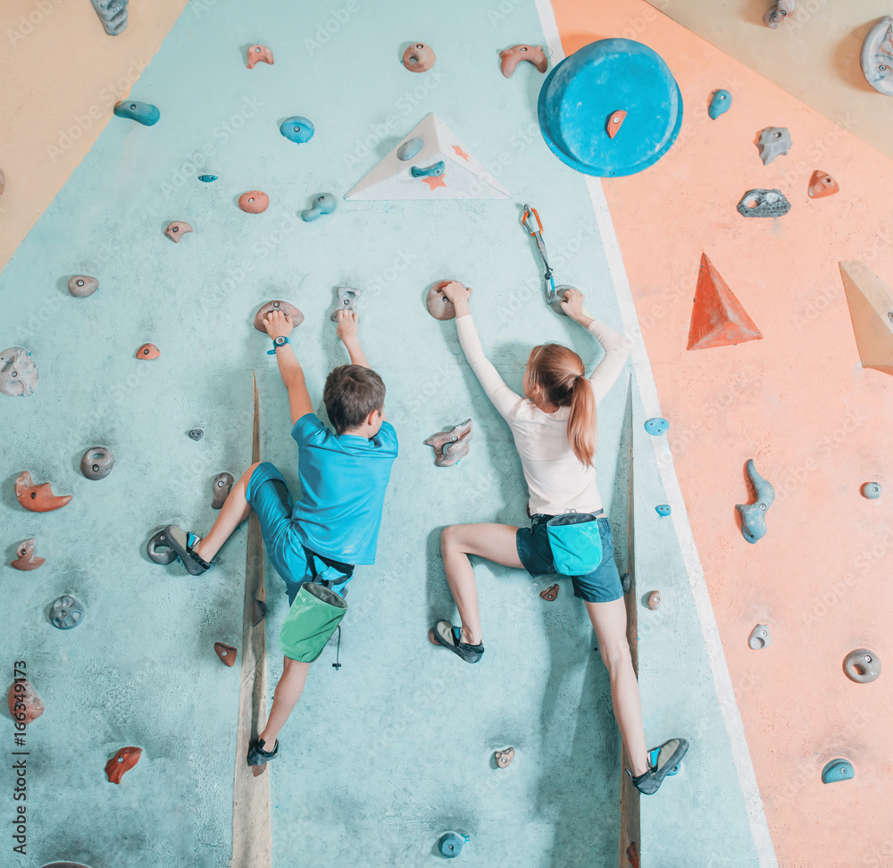 Two children climbing in gym. - obrazy, fototapety, plakaty 