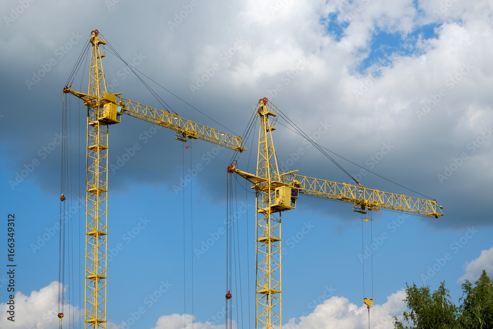 Tower crane on a background of clouds Tower crane on a background of clouds