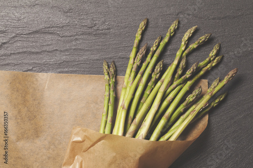 Fresh Asparagus tied on a rustic background