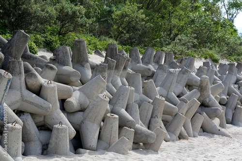 Stacked huge concrete blocks on a beach