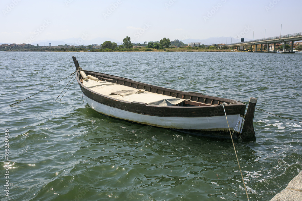 Little wooden boat in a river side