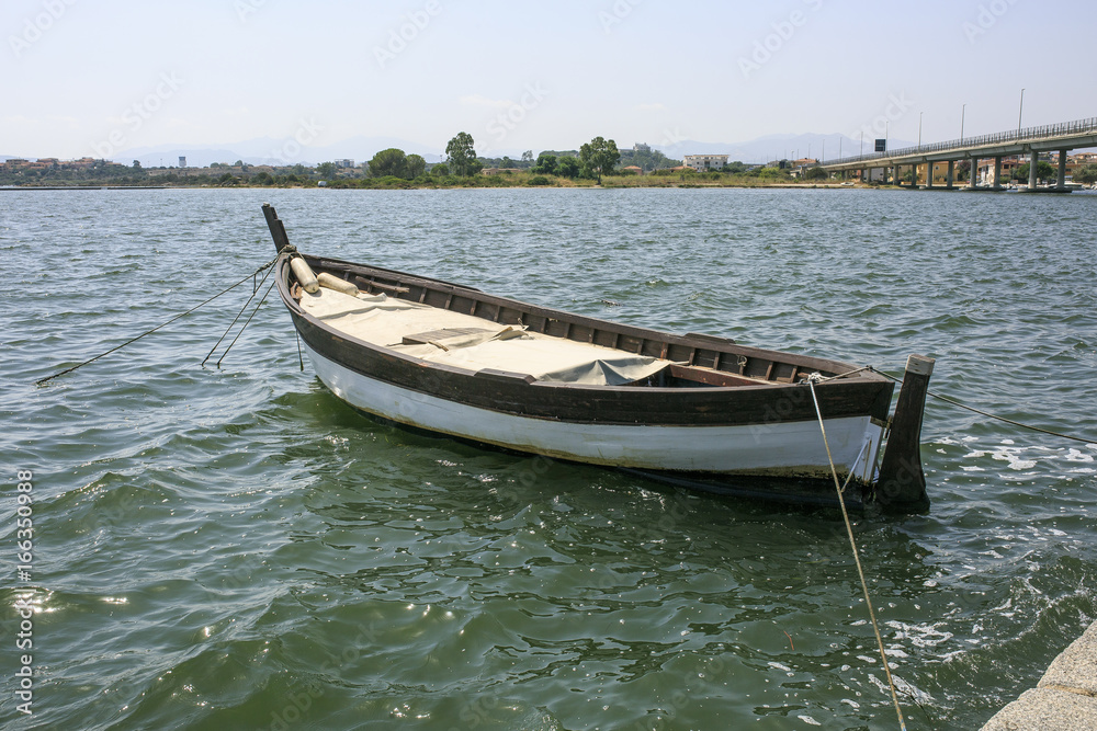 Little wooden boat in a river side Little wooden boat in a river side