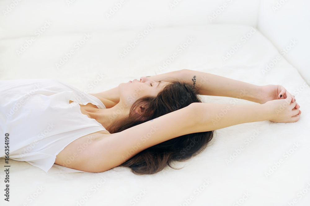 Girl lying on the bed and looking away Girl lying on the bed and looking away