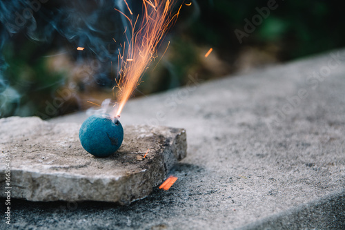Blue smoke bomb blowing sparks