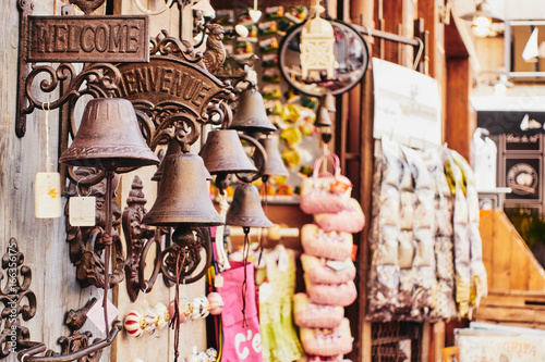 Welcome and Bienvenue signs and old bells at a decoration street shop in the Provence France