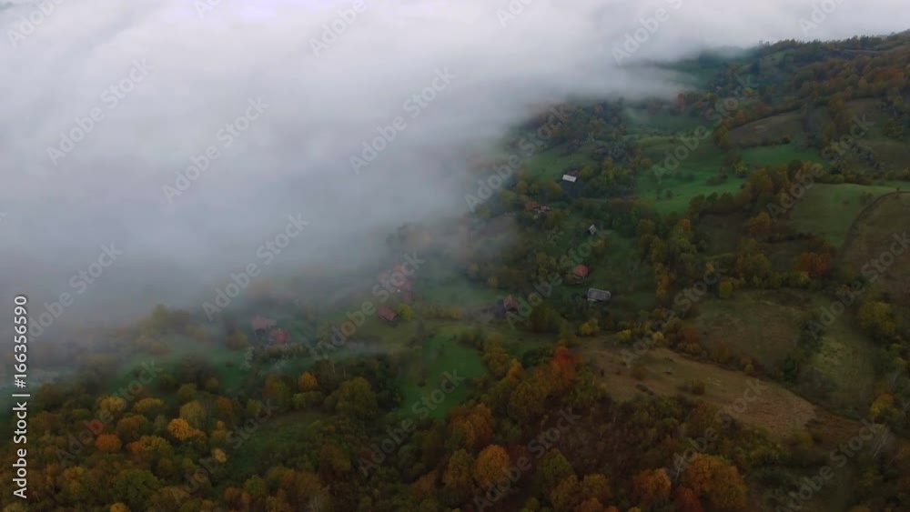 Aerial drone slow shot over colorful trees and green valleys. 4k footage, Romania.	Landscape near Salciua, apuseni, Mountains in autumn with early morning fog rising from Aries River.