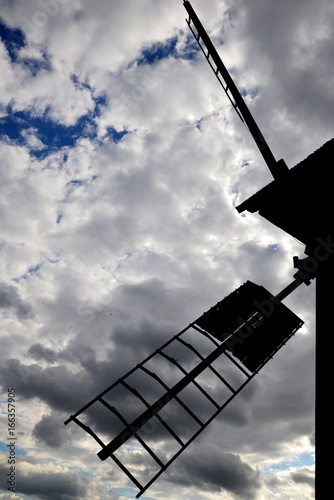 Obraz na płótnie Wing of cereal mill against sky with clouds w salonie